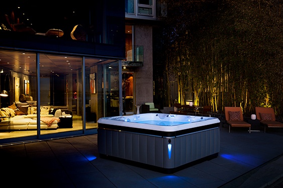 a luxury designer Utopia Tahitian hot tub sits center stage and exposed on a patio