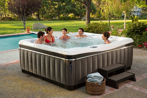 a large family rinses their swim suits well before using the hot tub