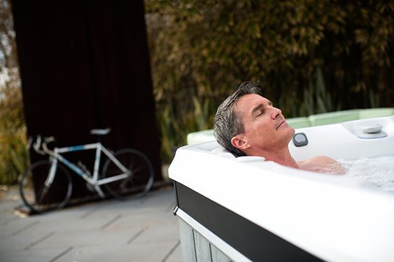 a man soaks in warm water hot tub therapy to fall asleep faster