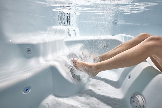 An image of a hot tubbers feet which are a perfect distance from the hot tub massage jets
