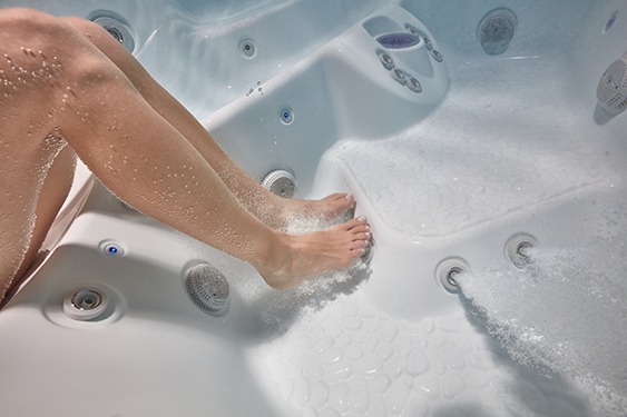 An underwater image of the perfect hot tub seat position in relation to the massage jets