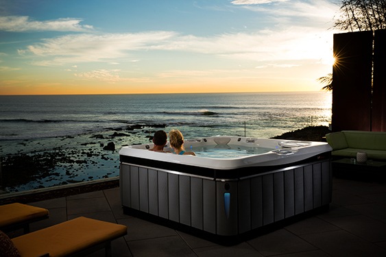 a couple takes a warm soak in a hot tub before bed