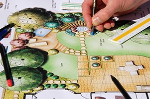 an artist working on an architectural drawing of a backyard hot tub design project