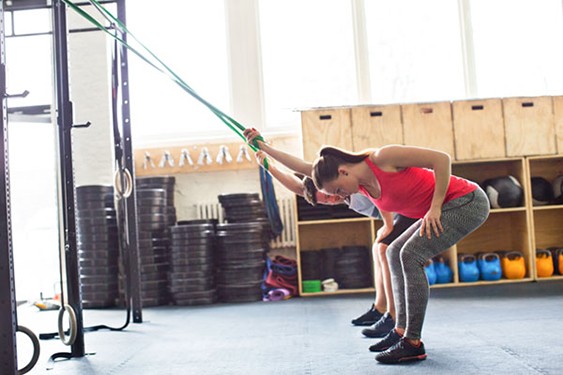 ladies workout in a gym before using a hot tub to help recover from muscle pain