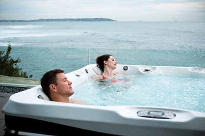A couple relaxing in a hot tub with soothing jets