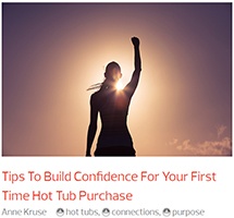 a woman triumphantly salutes the screen because she has learned tips to build confidence for buying the best hot tub in the world