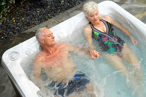 an older couple sleeps better and falls asleep faster after a soak in their hot tub