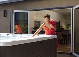 an image of a lady thinking about recycling her hot tub grey water
